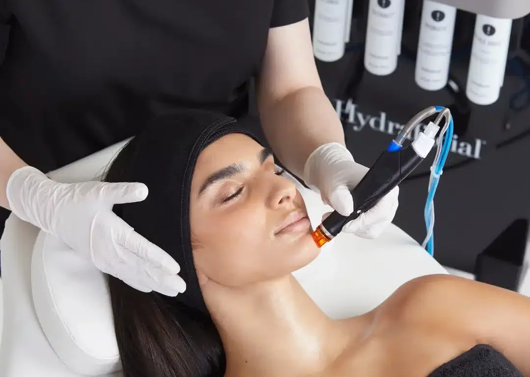 Guest enjoying a relaxing Hydrafacial treatment at luxury spa, experiencing rejuvenating skincare in tranquil setting.