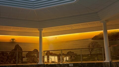 Luxurious indoor pool with skylight, comfy loungers, peaceful ambiance, and stunning views for ultimate relaxation.